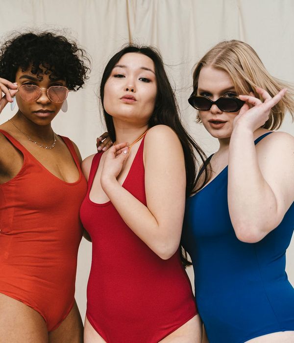 Diverse group of people in a bright, modern yoga studio.